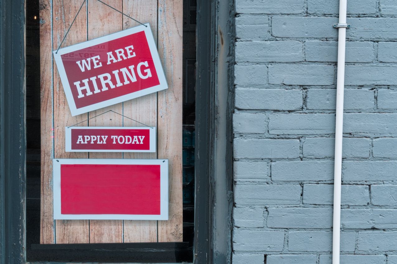 Schild an Tür "We are hiring - apply now"